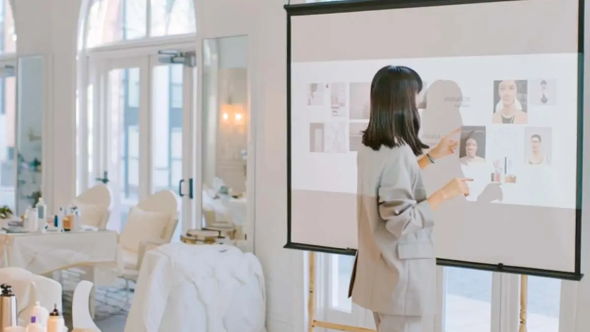 Healthcare professional reviewing peptide therapy patient profiles on a clinic screen